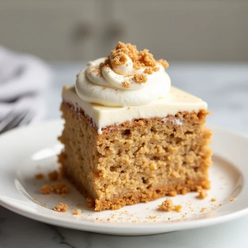 Moist carrot cake poke cake topped with cheesecake pudding and whipped topping in a glass baking dish