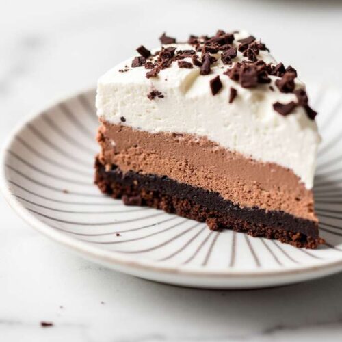 Gluten-Free Chocolate Mousse Cake topped with whipped cream and chocolate shavings