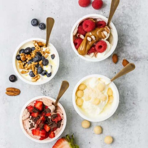 Chocolate strawberry Greek yogurt keto bowl topped with fresh fruit and dark chocolate
