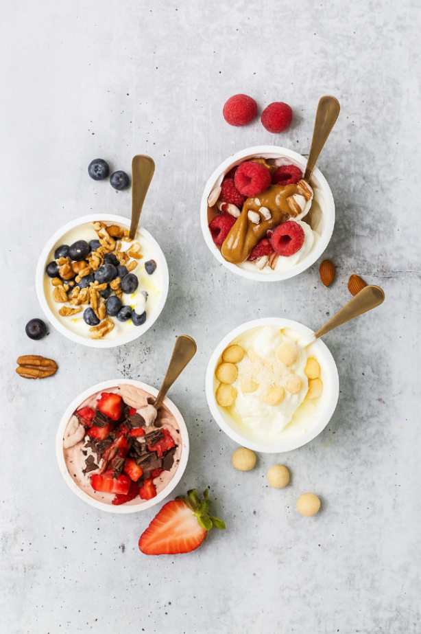 Chocolate strawberry Greek yogurt keto bowl topped with fresh fruit and dark chocolate