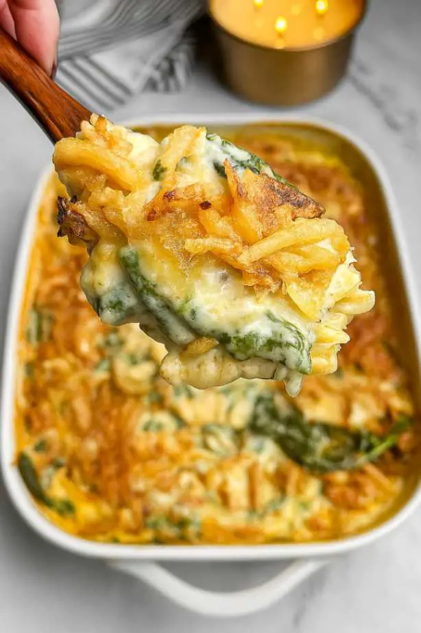 Baked Monterey Chicken One Pan Orzo topped with melted cheese and crispy onions in a white casserole dish