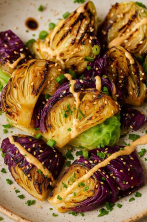 Bowl of Sweet Restaurant Slaw on a white marble table, with creamy dressing and fresh shredded cabbage