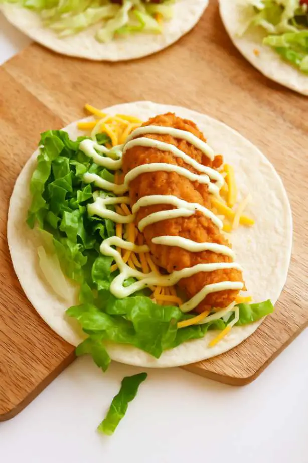 McDonald’s Snack Wrap with crispy chicken tender, shredded lettuce, cheddar cheese, and ranch sauce on a flour tortilla