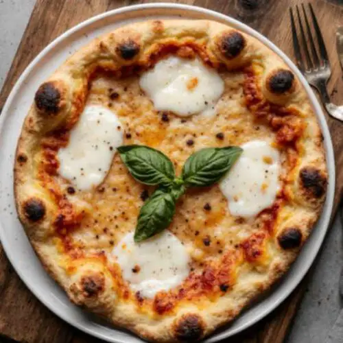 Finished Neapolitan pizza served on a wooden board with fresh basil on top