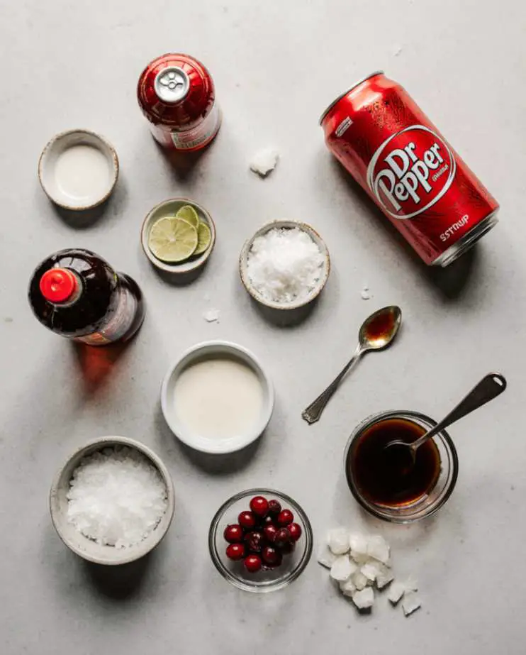 Glass of dirty soda with creamy swirl and garnishes on a rustic table